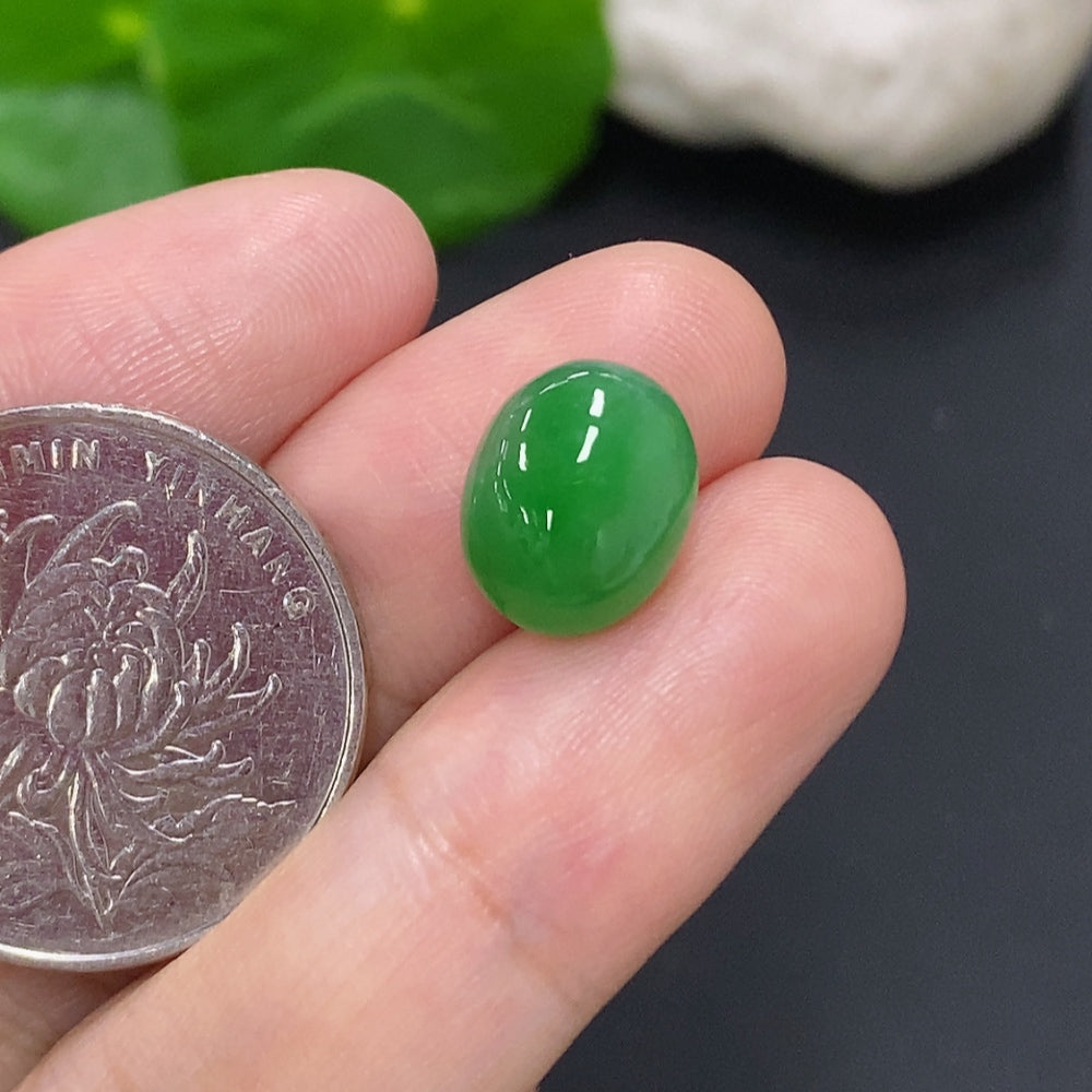 Jadeite cabochon jewelry piece featuring a smooth, polished green gemstone from HKHQ, weighing approximately 1.1 grams.