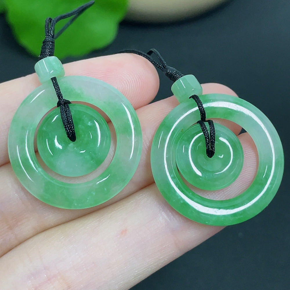 Jadeite pendant featuring mother-and-child design with cord, crafted by HKHQ, weighing approximately 6.11g.