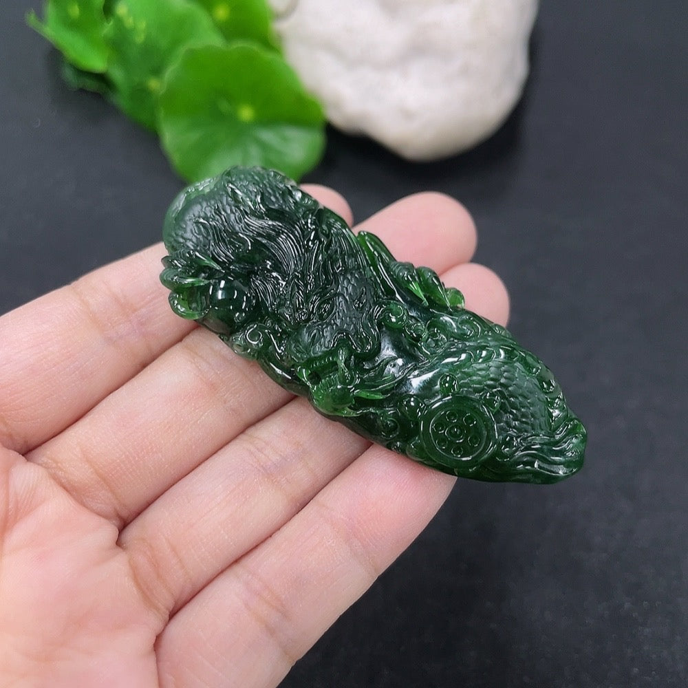 Jadeite pendant featuring a carved dragon plaque in green jade, weighing approximately 21.95g, from HKHQ.