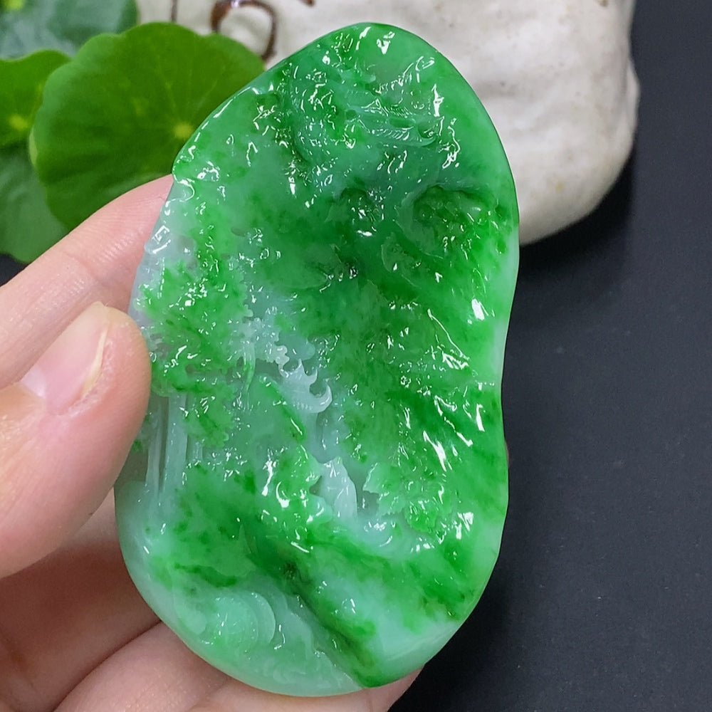 Jadeite landscape pendant from HKHQ, intricately carved jade jewelry weighing approximately 65.3 grams, featuring detailed mountain and river design.