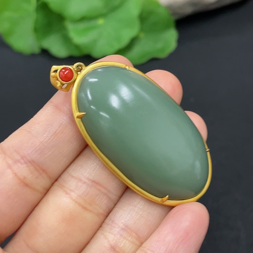 Hetian jade cabochon pendant necklace by HKHQ with 18K gold setting, featuring beads and weighing approx. 21.2g.