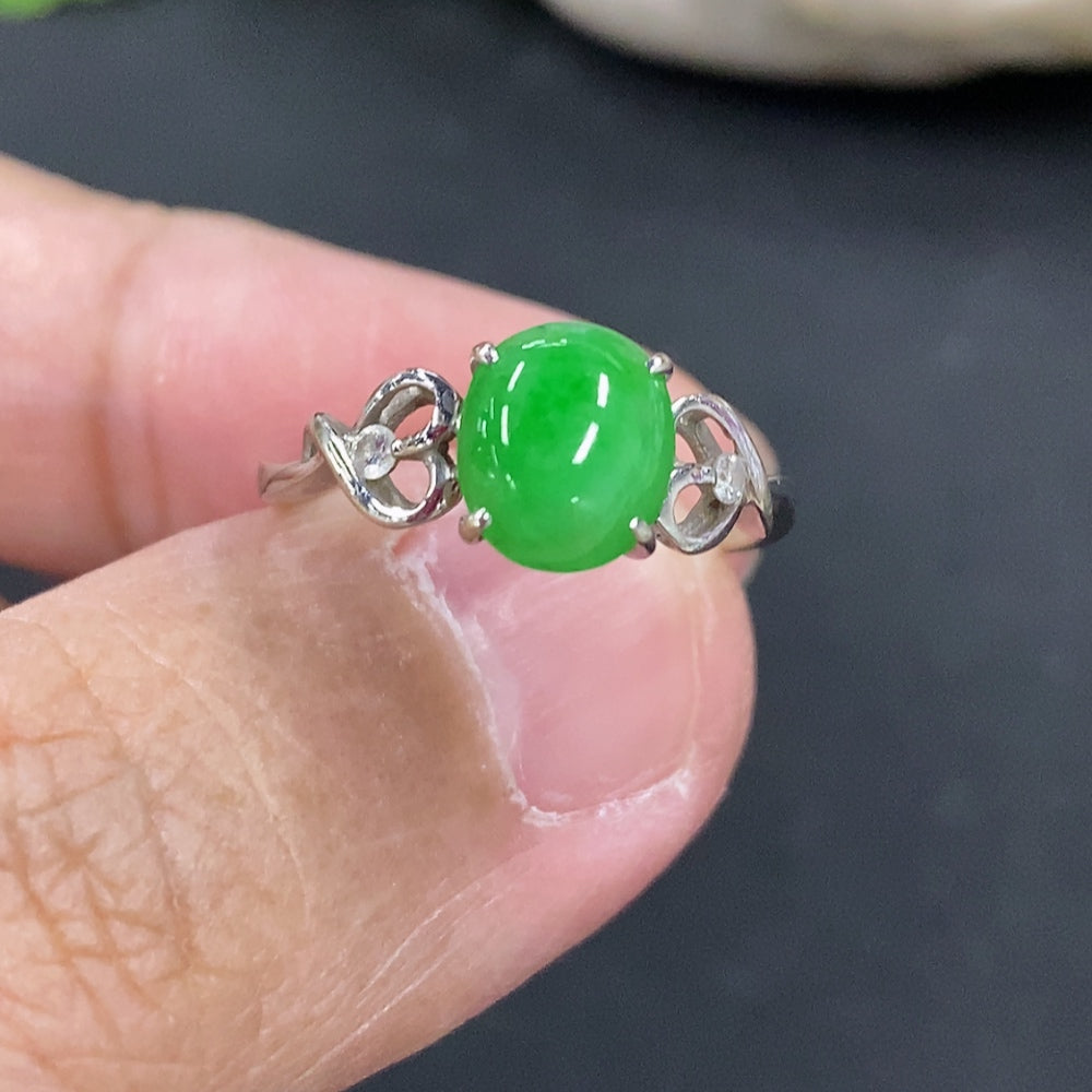 Jadeite cabochon ring with 18k gold setting, size 11.5, from HKHQ, showcasing a smooth green jade stone in a detailed gold band.
