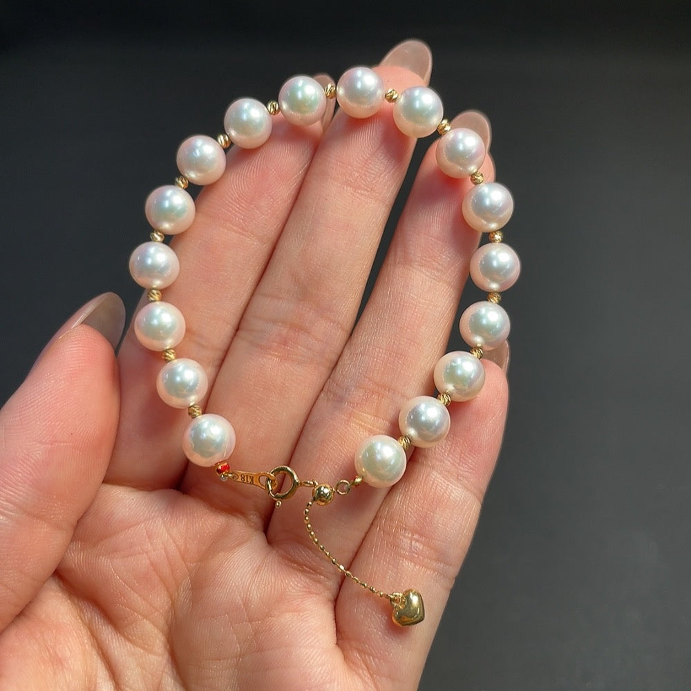 Seawater pearl bracelet by HKHQ featuring red-marked pearls on non-gold string, 7.1mm size, 10.15g weight.