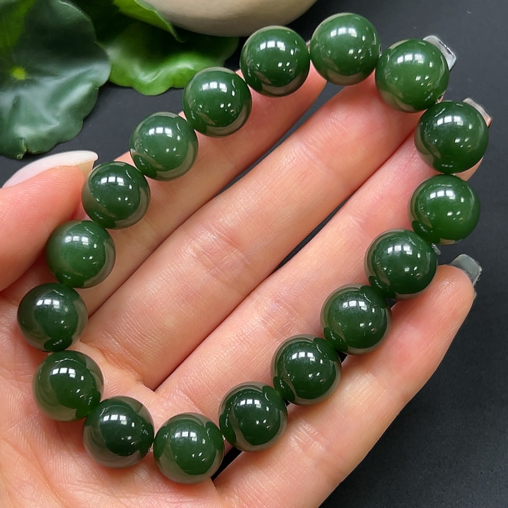 Hetian Jade bracelet with 12mm beads, weighing approximately 44.19g, featuring polished jade stones on a sleek strand.