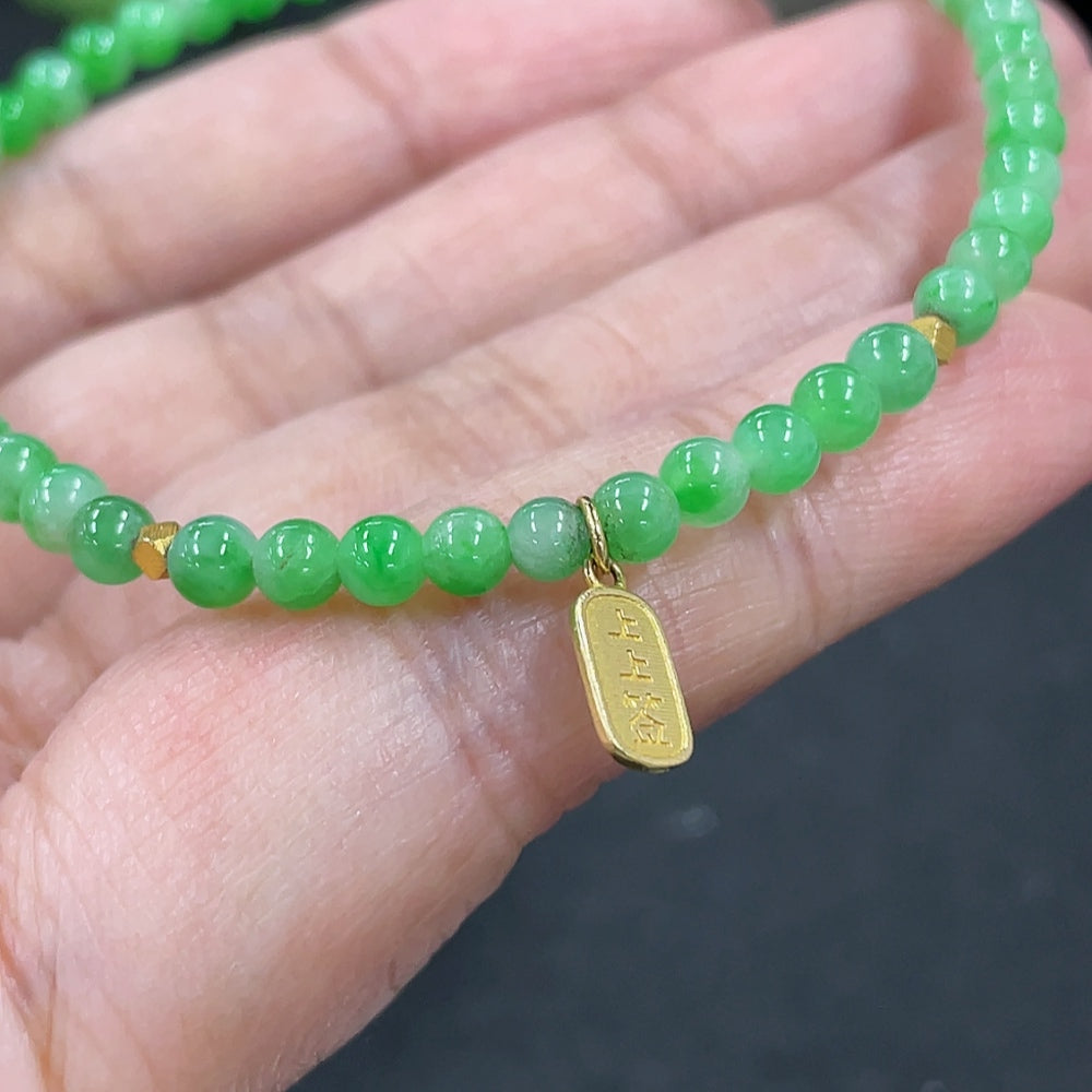 Jadeite bracelet with 3.7mm jade beads, weighing 4.6g, accented with 18k gold accessories, by HKHQ.
