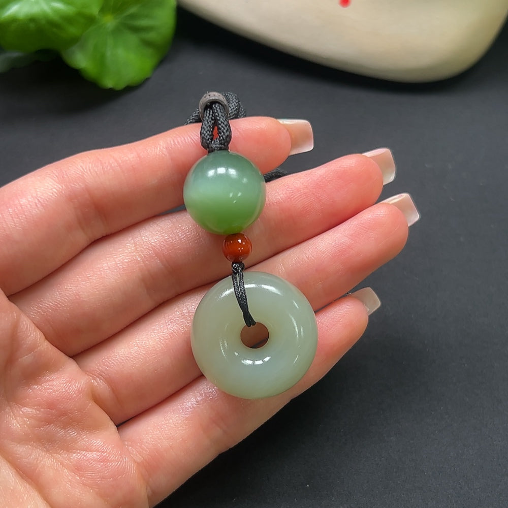 Hetian Jade Peace Knot pendant with Southern Red accents, HKHQ jade jewelry, featuring a rope chain and a total weight of 22.9g.