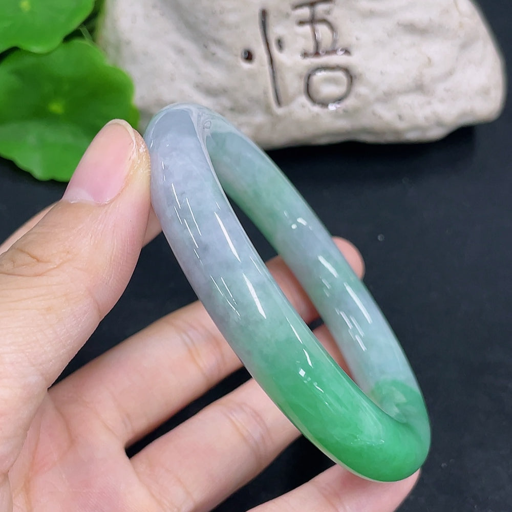 HKHQ jadeite round bangle with a 55.8mm size and 64.9g weight, showcasing smooth, polished green jade jewelry.