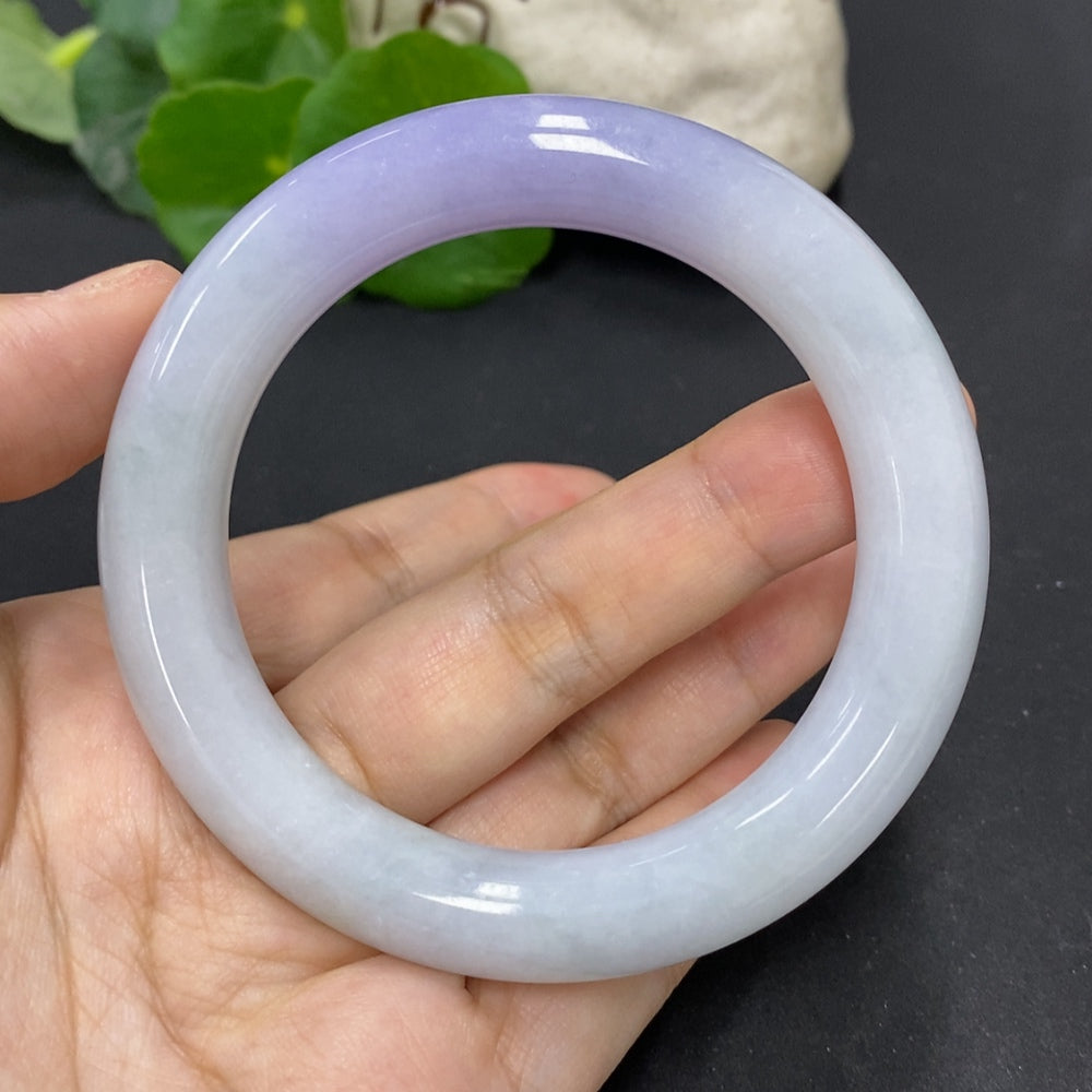 HKHQ jadeite round bangle, size 56.3, 77.3g, showcasing smooth, polished green jadeite bracelet on a plain background.