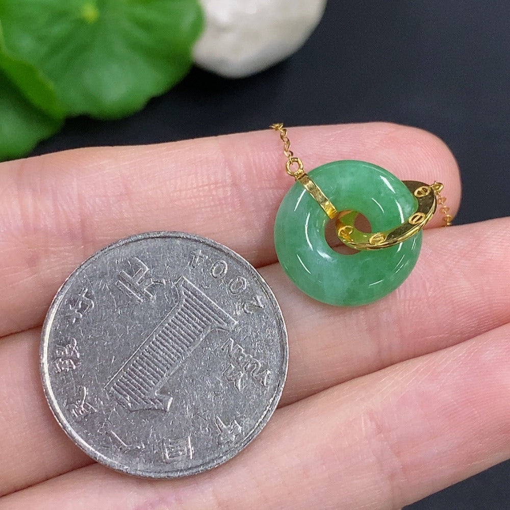 Jadeite donut pendant with 18k gold chain, HKHQ jewelry, showcasing a smooth, polished jade gemstone with gold accents.