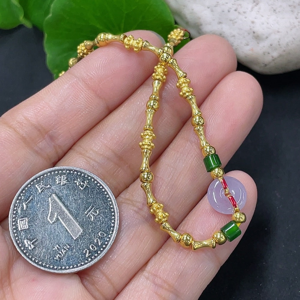 Jadeite inlaid bracelet with mixed gold components, featuring intricate gold accents and elegant design by HKHQ.