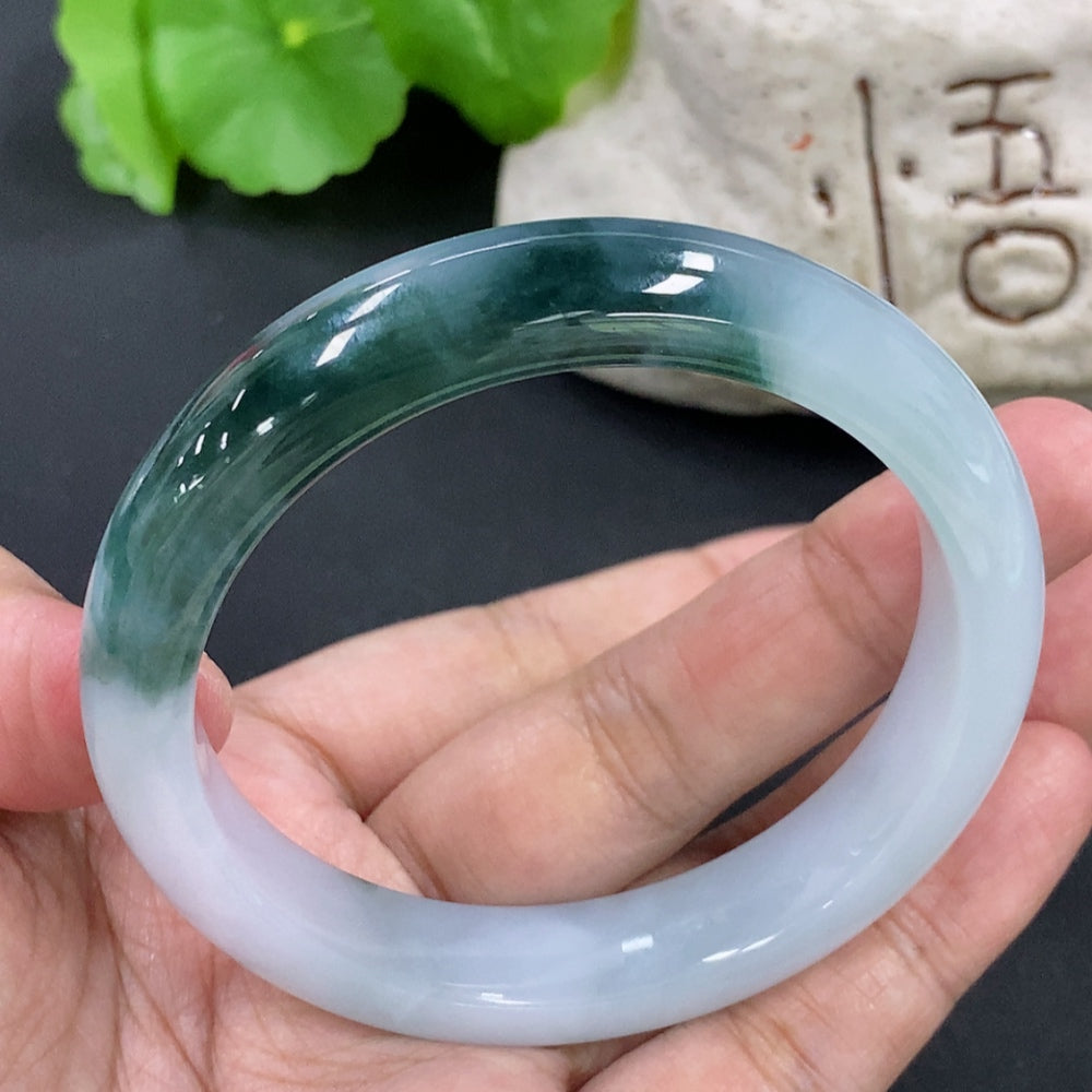 HKHQ jadeite round bangle with a 55.5mm size and 51.68g weight, showcasing smooth, polished green jadeite bracelet on a white background.