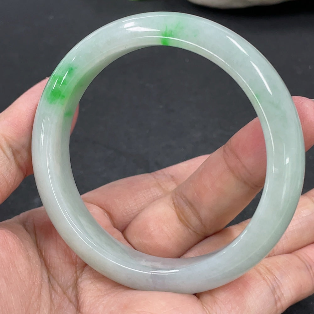 Jadeite round bracelet in natural green jade, weighing 48.16g, size 53.5mm, from HKHQ, displayed on a stand.