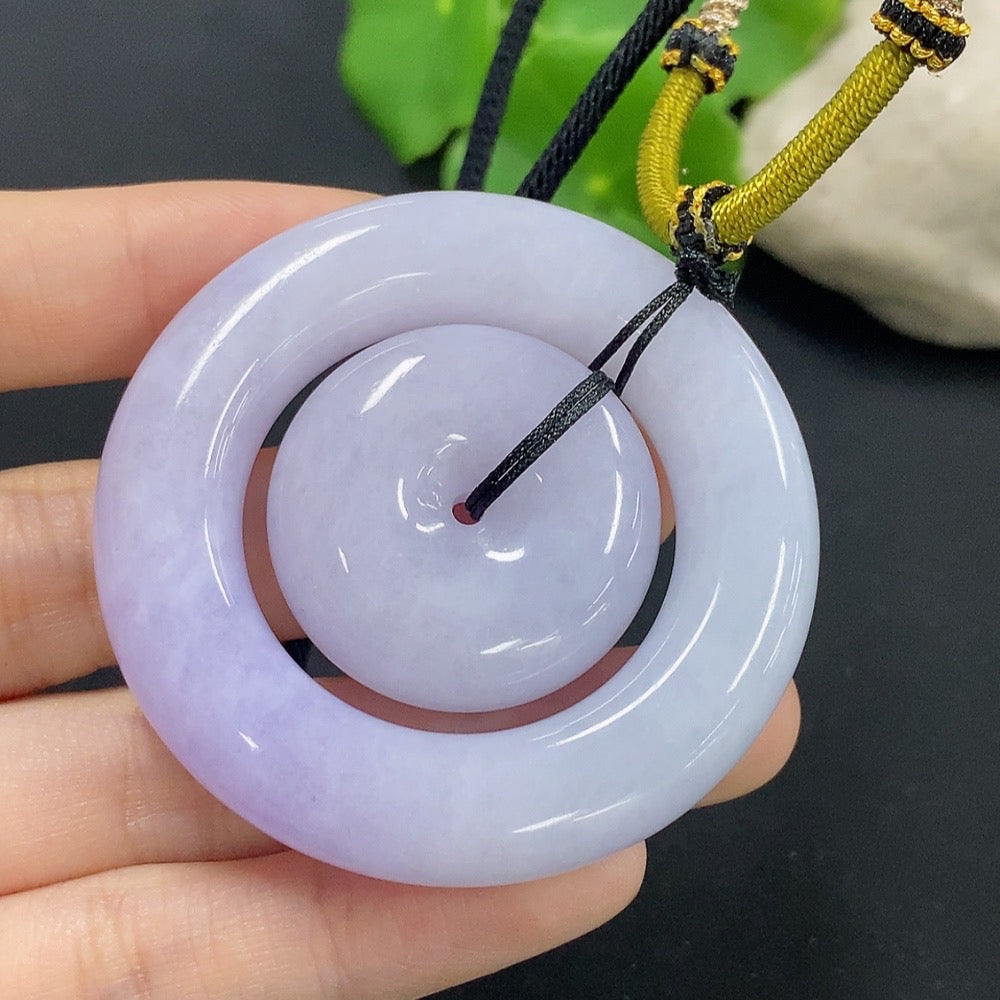 Jadeite mother-and-child toggle pendant with detailed carving, featuring vibrant green jade and a polished finish.
