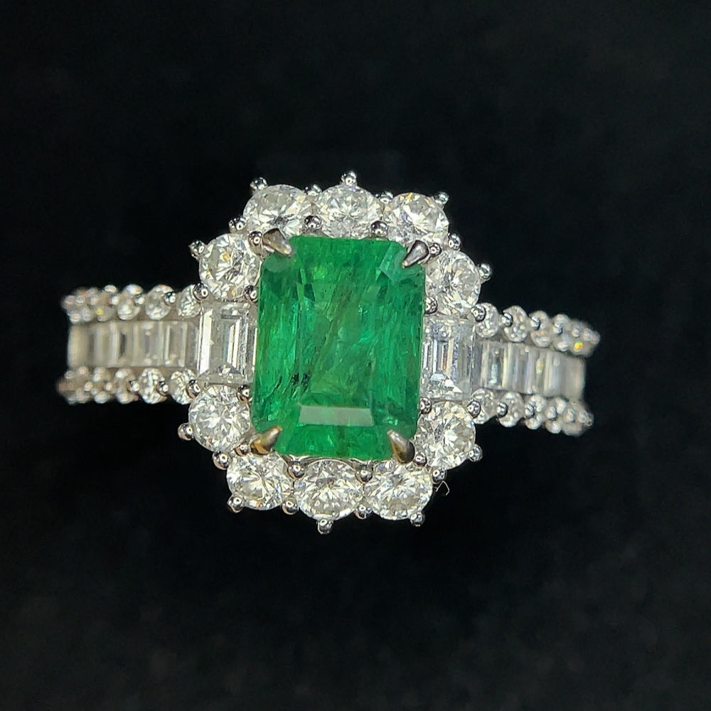 Emerald ring by HKHQ featuring a clarity-enhanced emerald set in 18K gold, size 19.5, with certificate and 6.23g total weight.