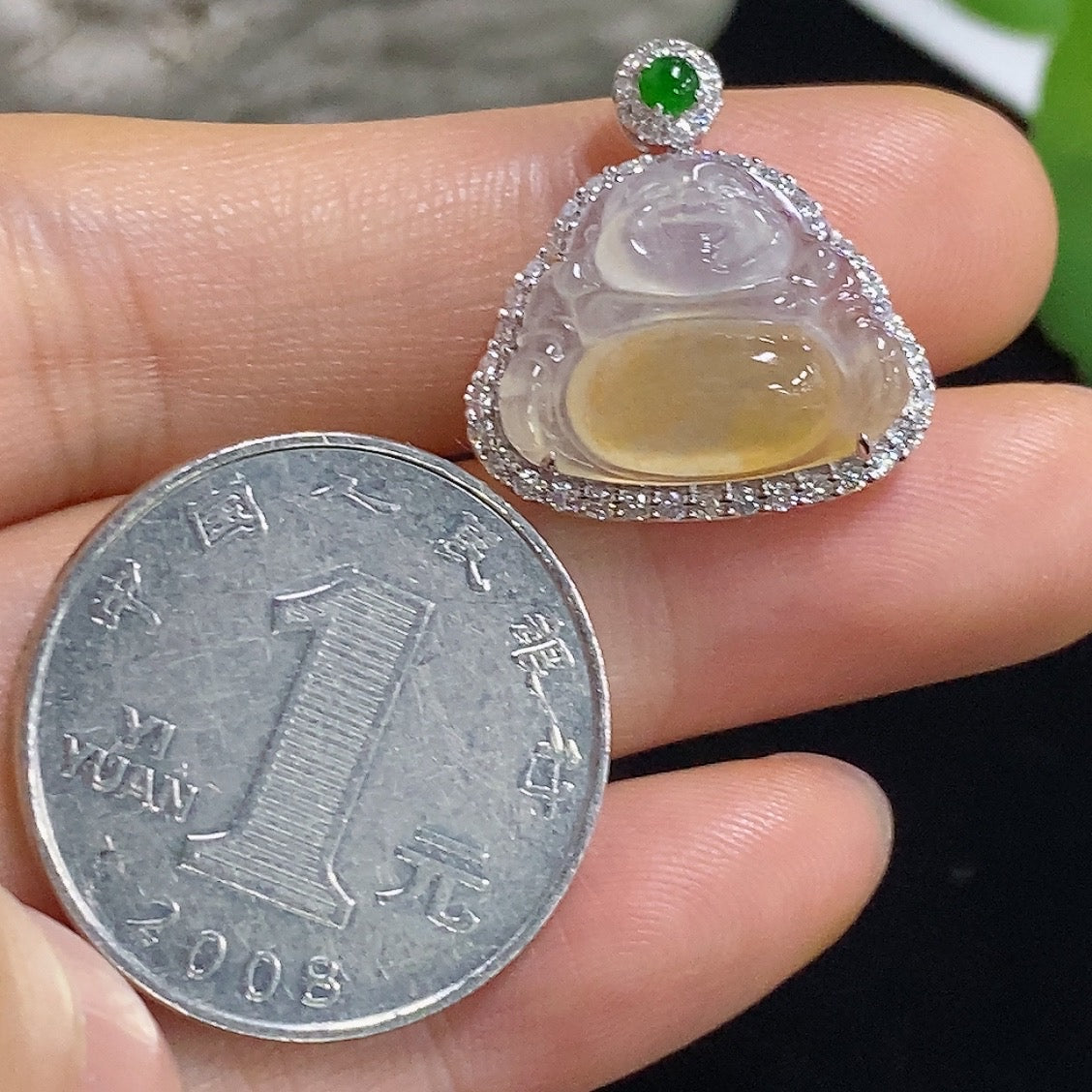 Jadeite Buddha pendant necklace with 18K gold and diamond accents, showcasing a detailed carved Buddha figure.