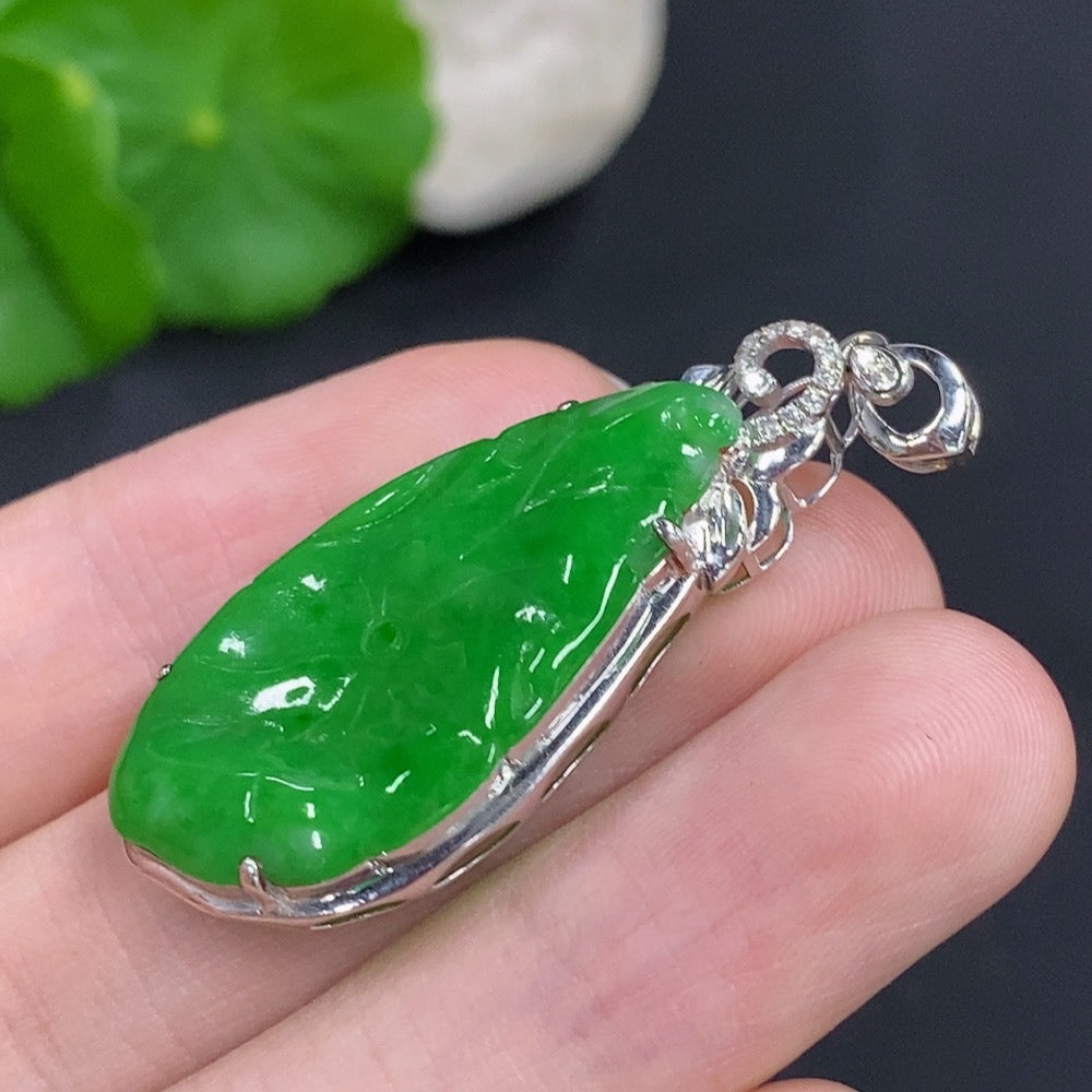 Jadeite lotus leaf pendant with 18K gold accents and diamond details, shown in close-up image.