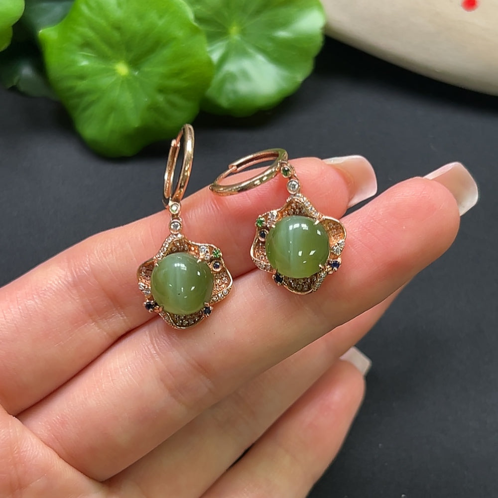 Hetian jade earrings with 18K gold and diamond accents, featuring intricate craftsmanship and elegant design.
