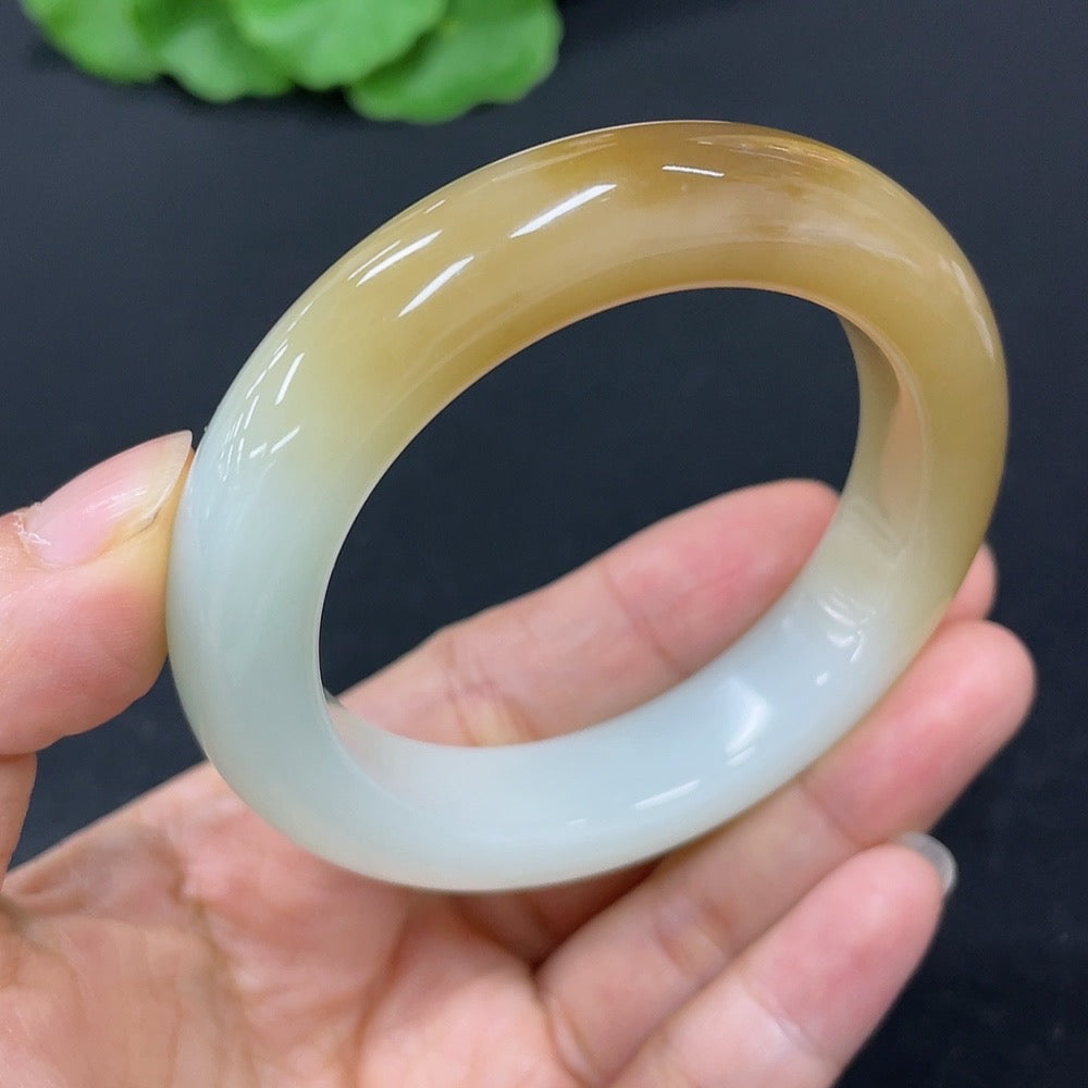 HKHQ Hetian Jade round bangle in size 51.3 with a smooth, polished surface, showcasing its elegant green hue and craftsmanship.