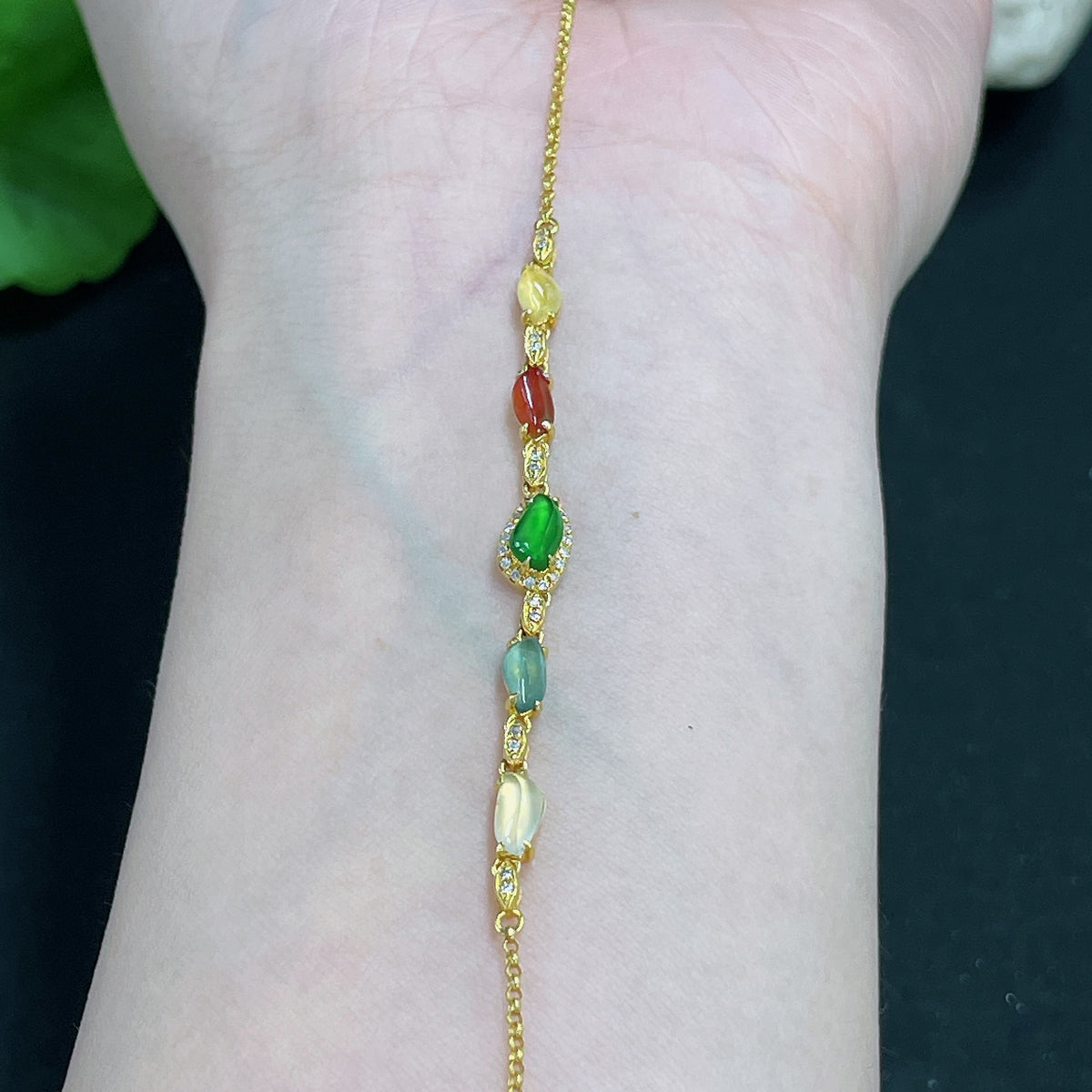 Jadeite bracelet with 18k gold inlay and diamond accents, weighing approximately 2.2g, showcasing fine craftsmanship.
