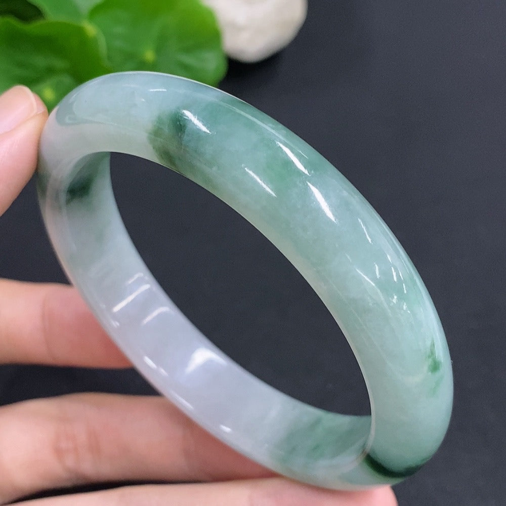 Jadeite round bangle with a 60mm size, weighing approximately 65.6g, showcasing smooth, polished green jade from HKHQ.