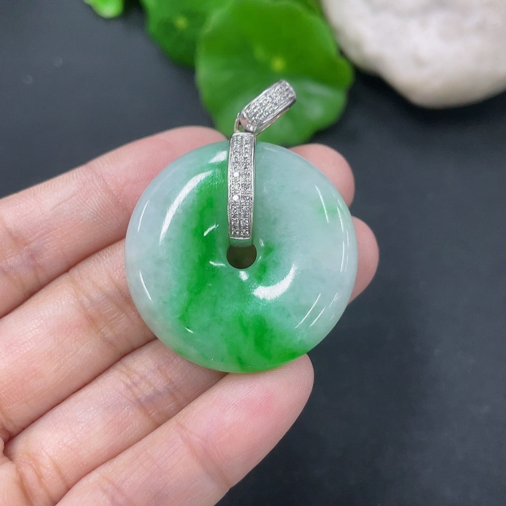 Jadeite pendant with peace knot design, 18k gold accents, and diamond details, weighing approximately 16.12 grams.