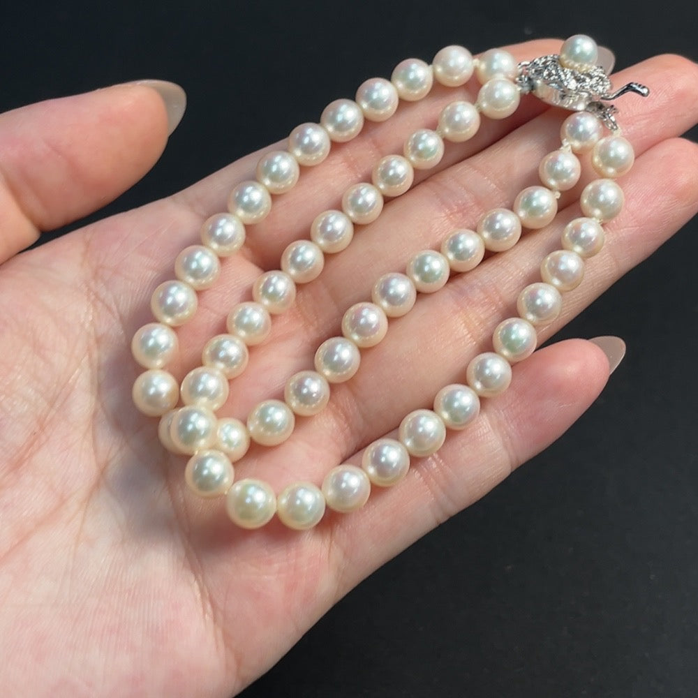 Seawater pearl strand from HKHQ featuring 6.4mm pearls, total weight approx. 21.19g, showcasing lustrous non-gold pearls.