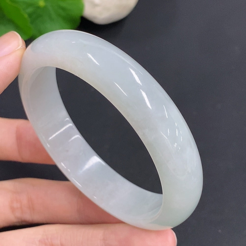 Jadeite round bangle with a total weight of 52.7g, size 55.7, crafted by HKHQ, displayed on a plain background.