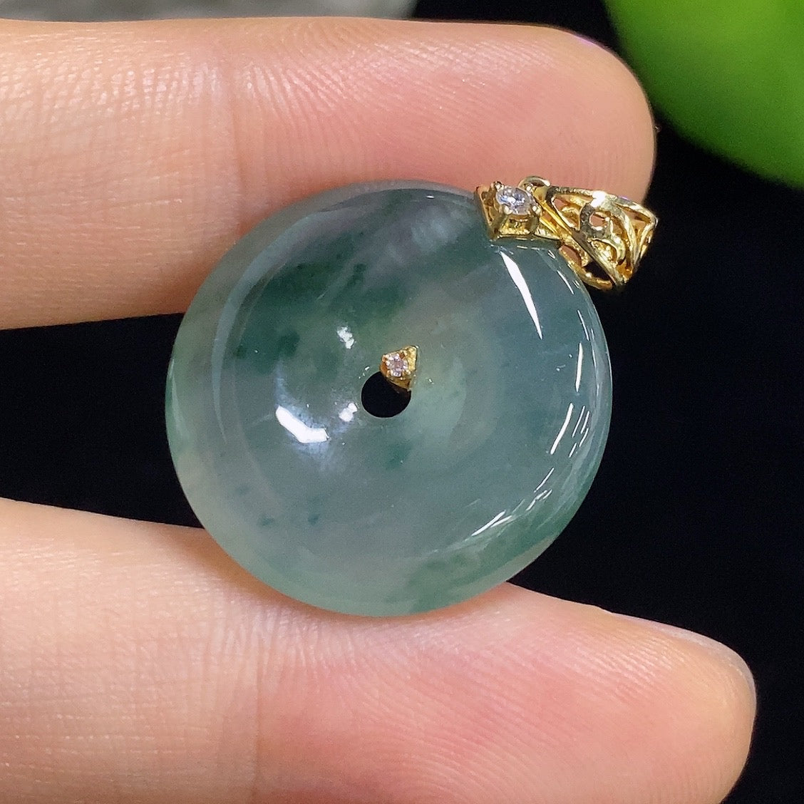 Jadeite Peace Knot pendant in 18k gold with diamond inlay, showcasing intricate craftsmanship and elegant design.