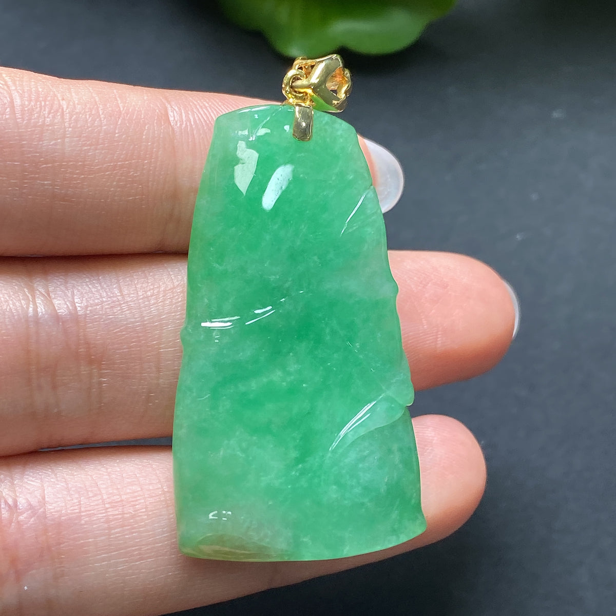 Elegant jadeite pendant featuring bamboo design in 18K gold, crafted by HKHQ, showcasing intricate detailing and vibrant green jade.