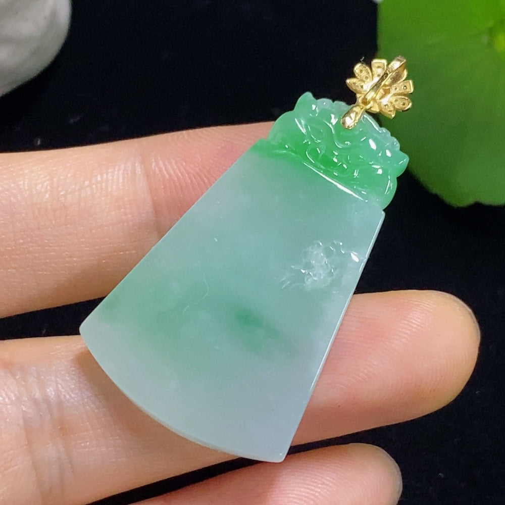 Jadeite Pi Xiu pendant with 18K gold accents and diamond details, showcasing intricate craftsmanship and a polished finish.