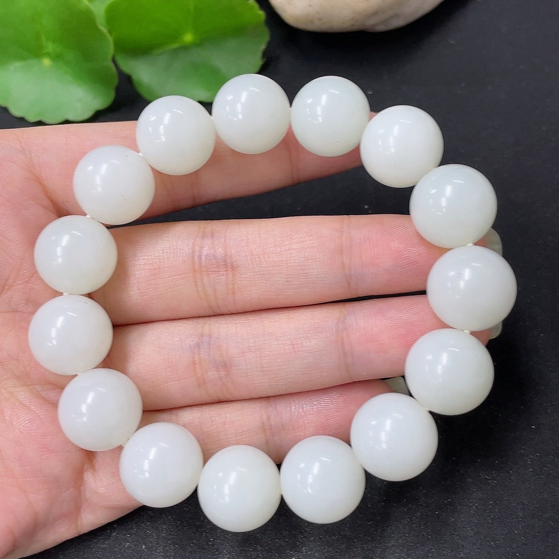 Hetian Jade bracelet with 13.6mm beads, weighing approximately 62g, showcasing smooth, polished jade stones from HKHQ.