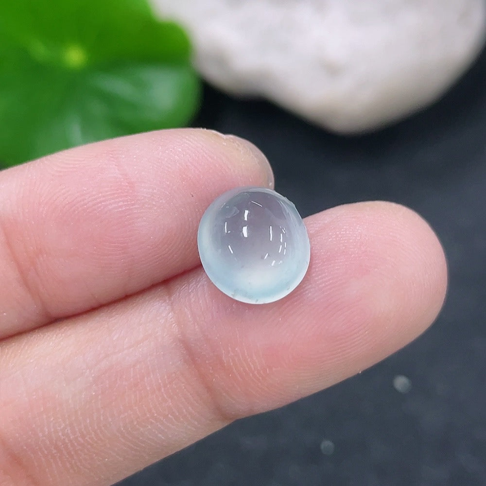 Jadeite cabochon gemstone in jewelry setting, 0.71g, featuring smooth, polished green jadeite with natural variations and shine.