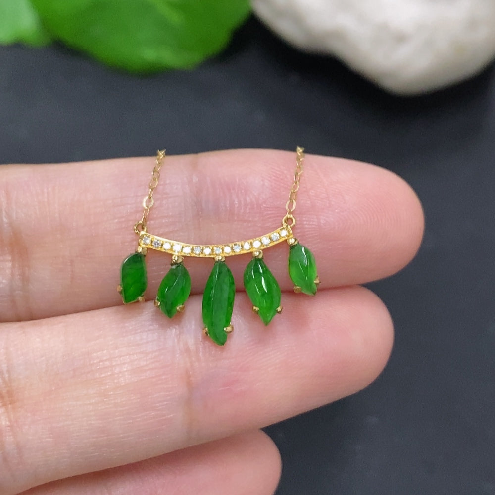 Jadeite inlaid pendant with 18K gold and diamond accents, showcasing a polished jade jadeite stone and intricate gold setting.