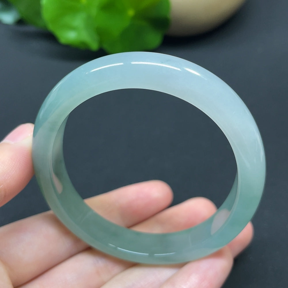 HKHQ jadeite oval bangle in size 55.6 with a weight of 35.37g, showcasing smooth, polished jadeite in an elegant oval shape.