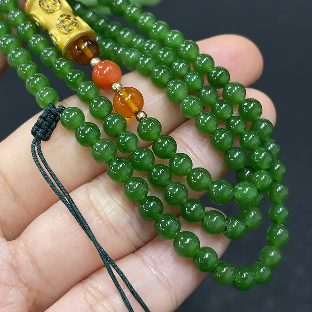 Elegant Hetian Jade beaded necklace featuring smooth, polished green jade beads on a delicate string.
