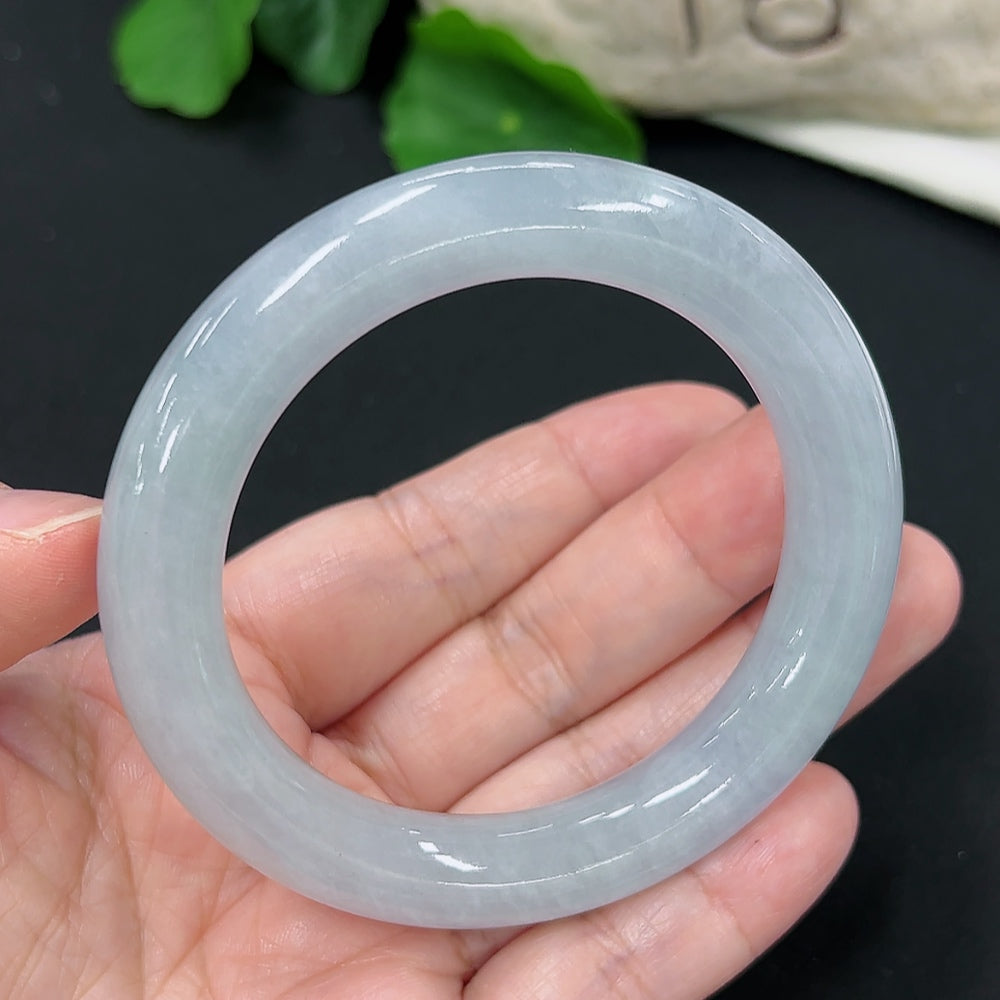 Smooth jadeite round bangle from HKHQ featuring polished green jade with a glossy finish.