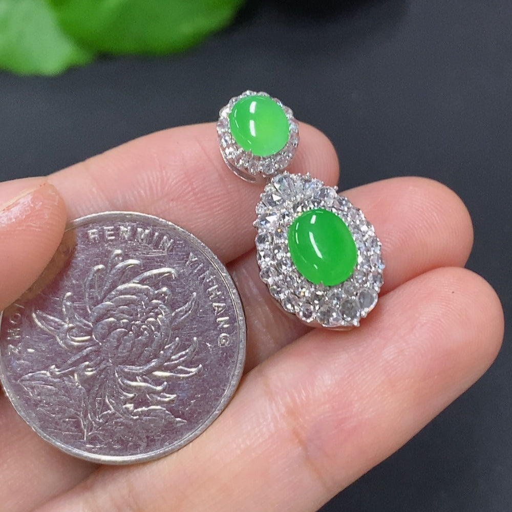 Jadeite cabochon pendant with diamond accents in 18K gold, showcasing a smooth green jade gemstone and elegant gold setting.