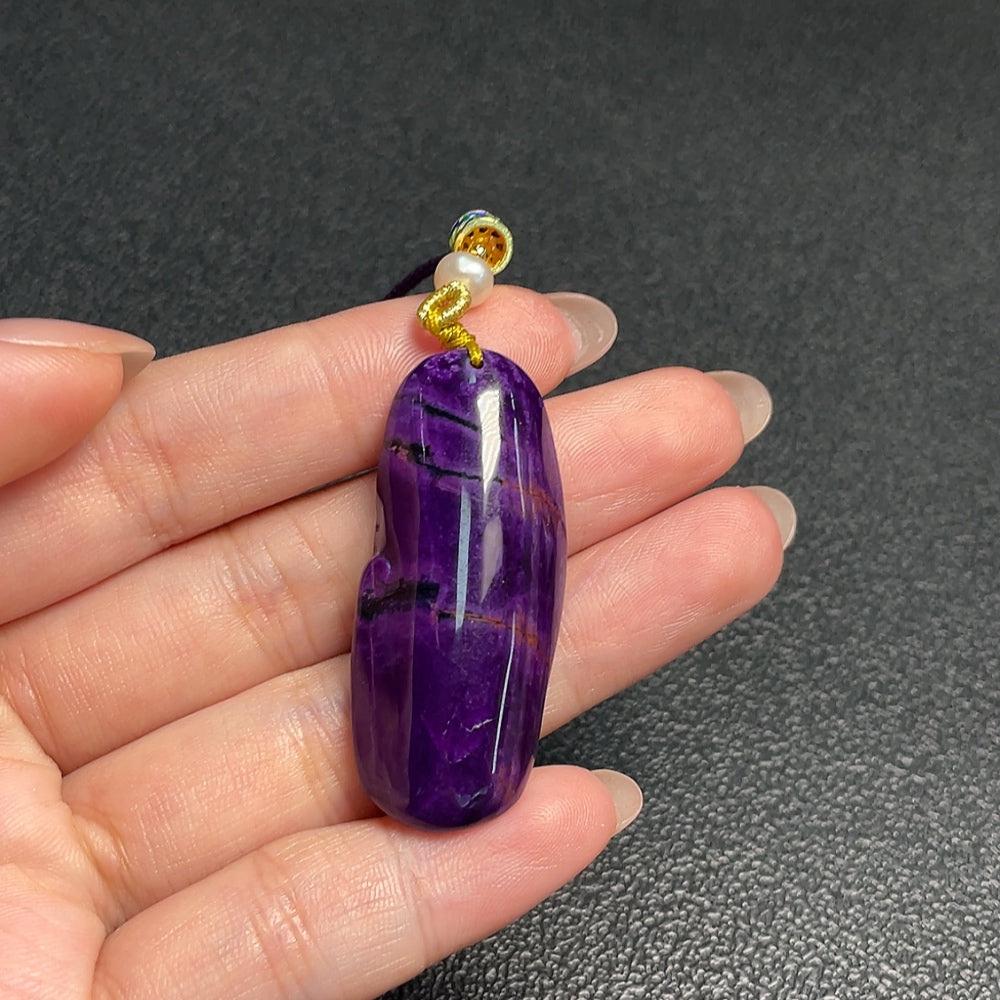 Sugilite pendant with other mineral components, total weight approximately 11.73g including rope, non-gold