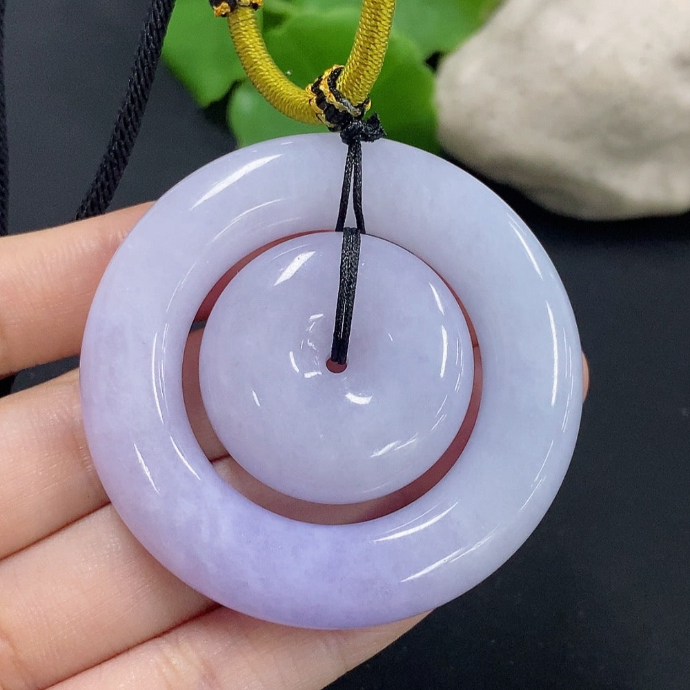 Jadeite mother-and-child toggle pendant from HKHQ featuring carved jade figures, weighing approximately 55.29 grams.