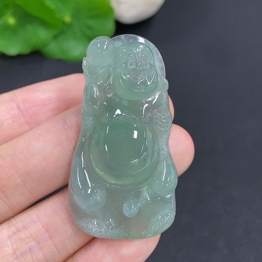 Jadeite Maitreya pendant from HKHQ featuring a detailed carved jade figure, weighing approximately 16.2 grams.