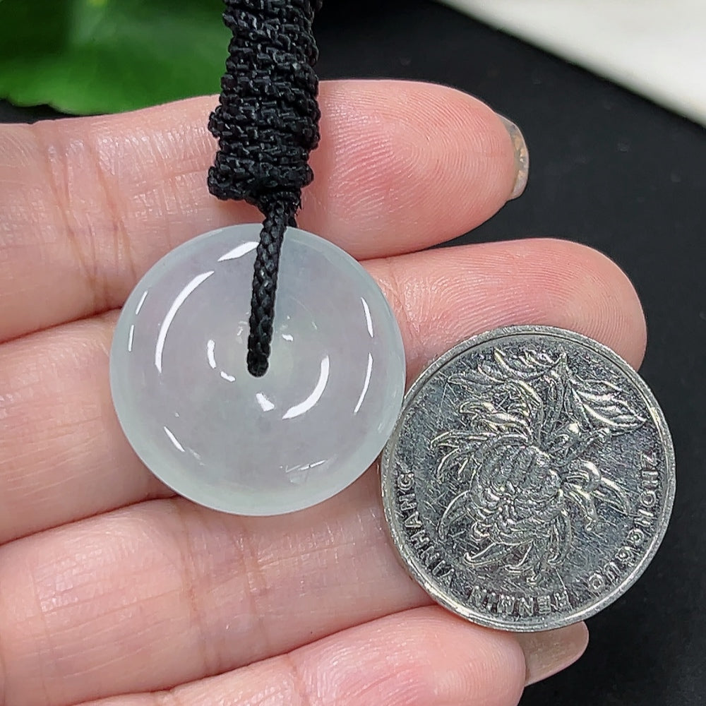 Jadeite Peace Knot pendant with a smooth, polished surface, hanging on a woven rope, weighing approximately 7.1 grams.
