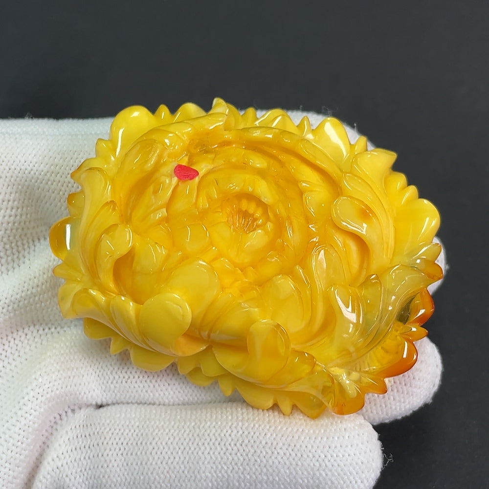 Amber beeswax pendant with visible repairs, weighs approximately 36.25g, crafted by HKHQ, showcasing natural amber texture and craftsmanship.